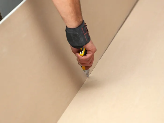 Cutting plasterboard to fit during application of pu foam for use in installing plasterboard