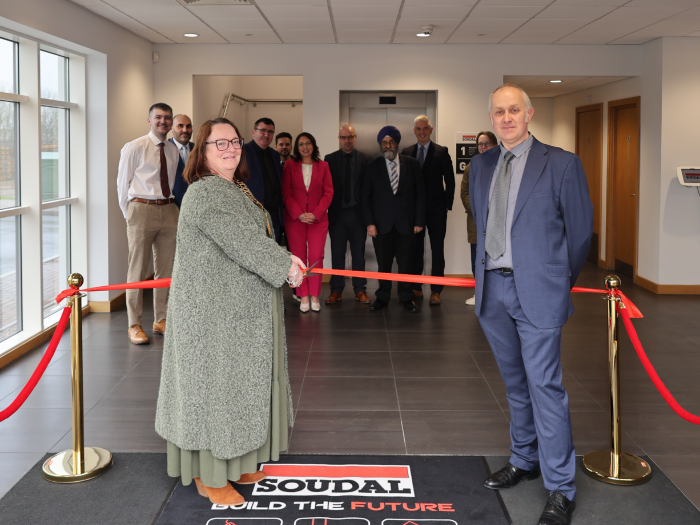 Councillor Debbie Bates performs a ribbon cutting at Soudal UK's new NDC alongside Michael Gamble